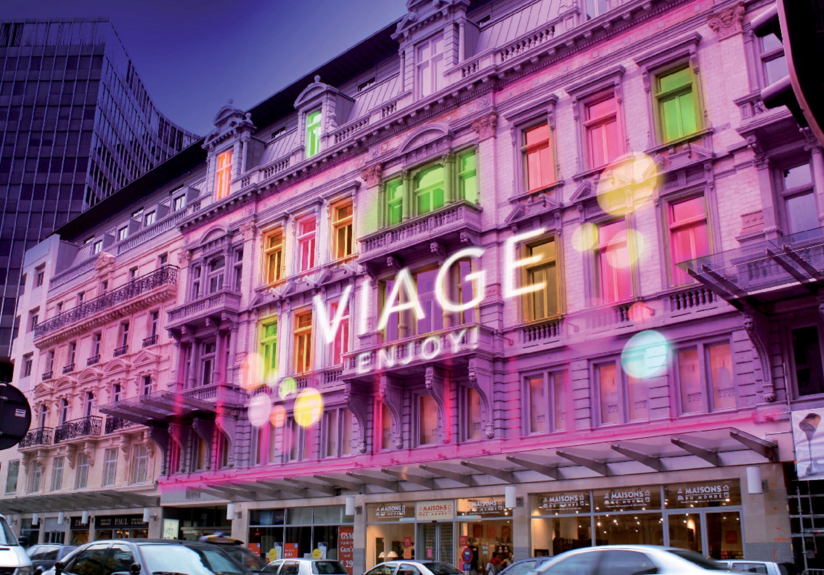 VIAGE Casino building facade illuminated with colorful lights and the sign VIAGE ENJOY!